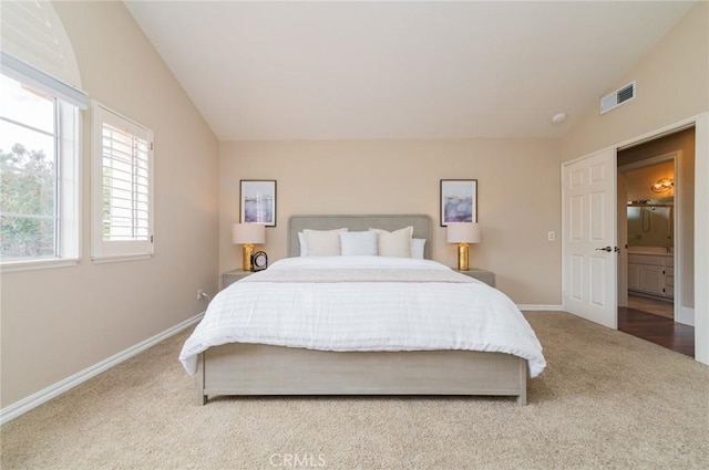 carpeted bedroom with lofted ceiling, baseboards, and visible vents