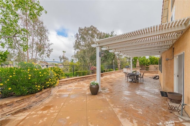 view of patio featuring outdoor dining area, a fenced backyard, and a pergola