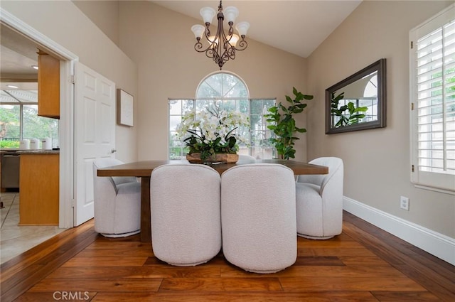 dining space featuring plenty of natural light, a notable chandelier, and wood finished floors