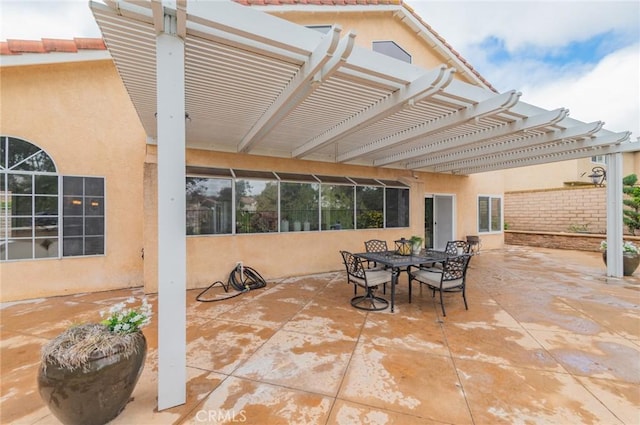 view of patio featuring a pergola and outdoor dining area