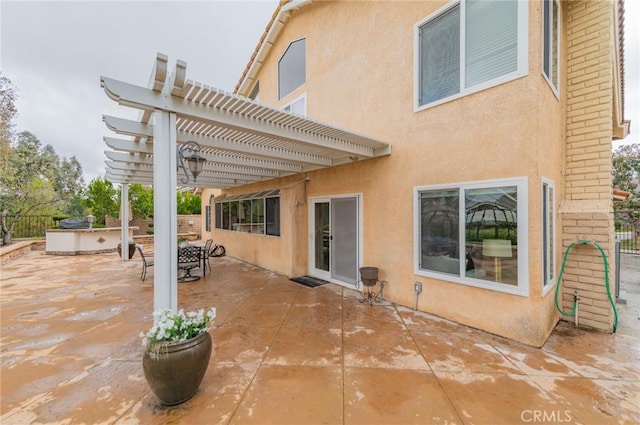 view of patio / terrace featuring an outdoor kitchen, a pergola, and fence