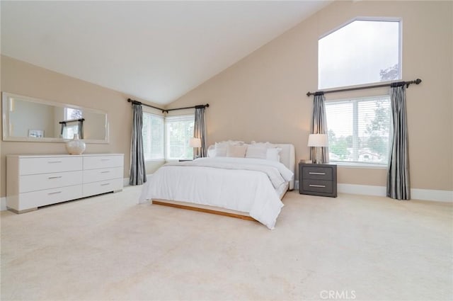 bedroom featuring baseboards, multiple windows, light colored carpet, and high vaulted ceiling