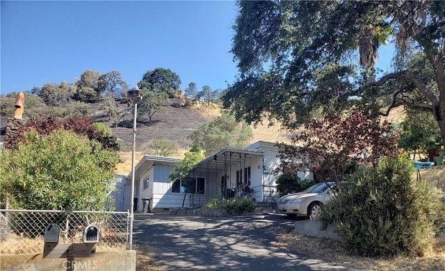 12998 Lakeshore Dr, Clearlake, CA 95422 - view of front of property with aphalt driveway, board and batten siding, and fence