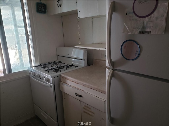 12998 Lakeshore Dr, Clearlake, CA 95422 - kitchen with white cabinetry, white appliances, and light countertops