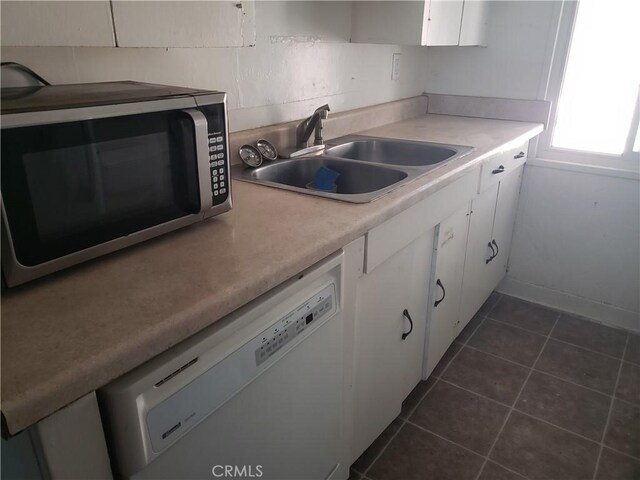 12998 Lakeshore Dr, Clearlake, CA 95422 - kitchen featuring white dishwasher, a sink, white cabinetry, stainless steel microwave, and dark tile patterned floors