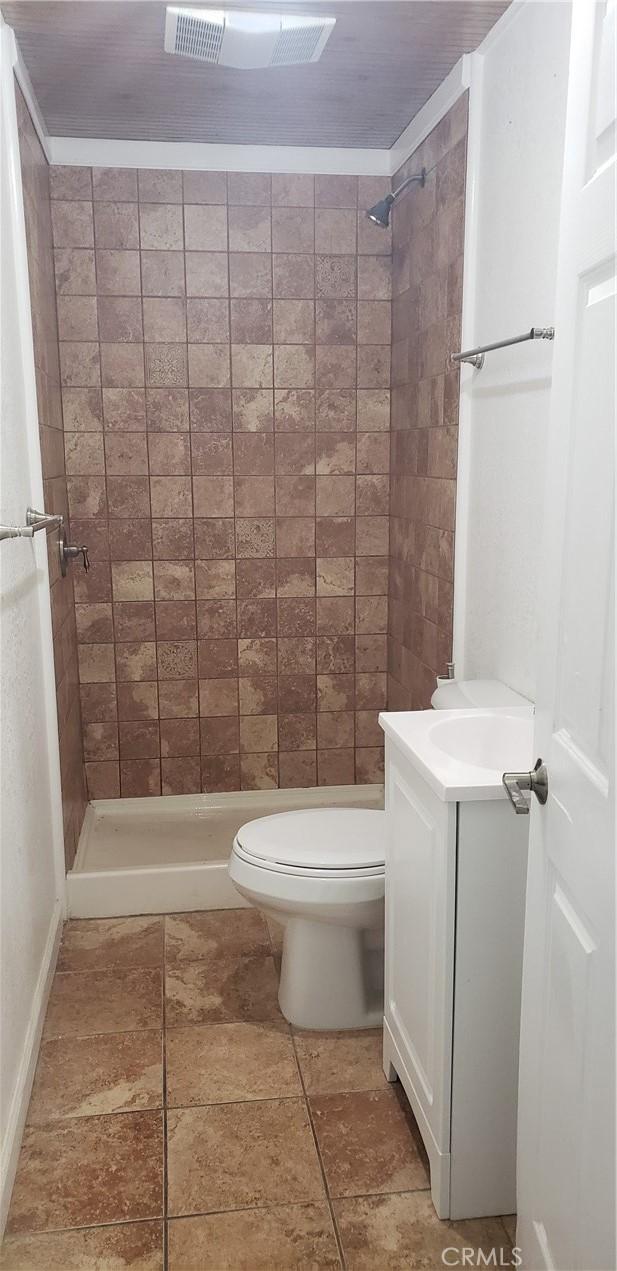12998 Lakeshore Dr, Clearlake, CA 95422 - bathroom featuring toilet, a stall shower, and vanity