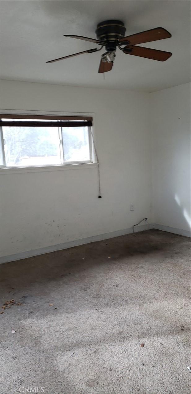 12998 Lakeshore Dr, Clearlake, CA 95422 - empty room with baseboards and ceiling fan