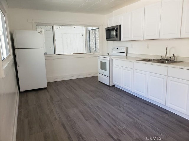 12998 Lakeshore Dr, Clearlake, CA 95422 - kitchen featuring white appliances, dark wood finished floors, a sink, white cabinets, and a wealth of natural light