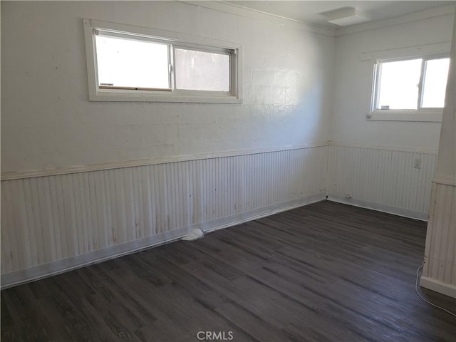 12998 Lakeshore Dr, Clearlake, CA 95422 - spare room featuring a wainscoted wall and dark wood-style flooring