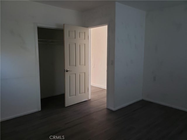 12998 Lakeshore Dr, Clearlake, CA 95422 - unfurnished bedroom with dark wood-type flooring, baseboards, and a closet