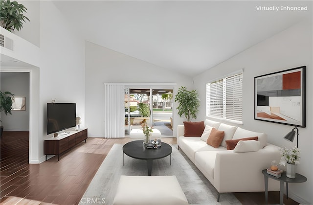 living area featuring visible vents, high vaulted ceiling, baseboards, and wood finished floors