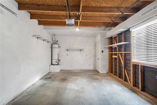 garage with strapped water heater and a garage door opener