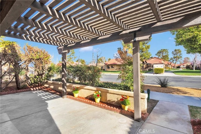 view of patio / terrace with a pergola and a residential view