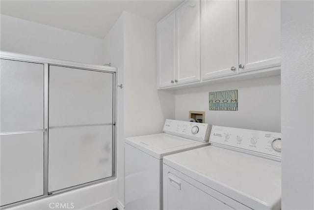 laundry room featuring washing machine and clothes dryer and cabinet space