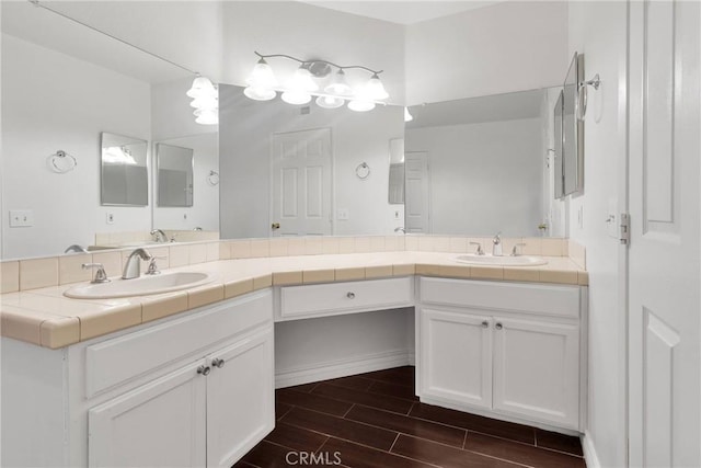 full bath featuring a sink, wood finish floors, and double vanity