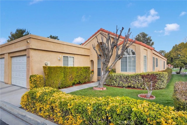 mediterranean / spanish-style house with stucco siding, an attached garage, and a front lawn