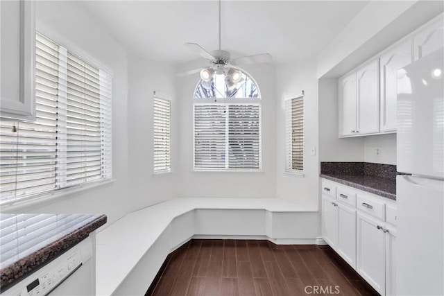 unfurnished dining area with ceiling fan and wood tiled floor