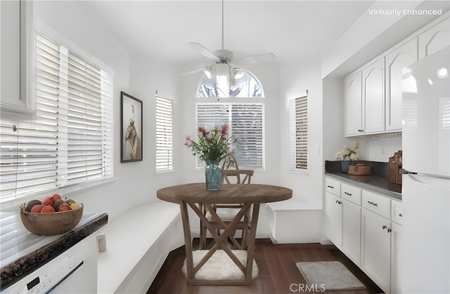 dining room featuring dark wood-style floors, baseboards, and a ceiling fan