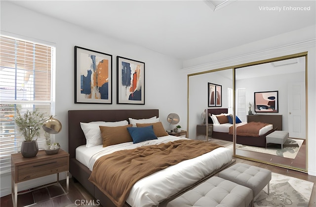 bedroom featuring wood finished floors and a closet