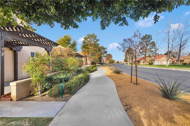 surrounding community featuring a residential view and a pergola