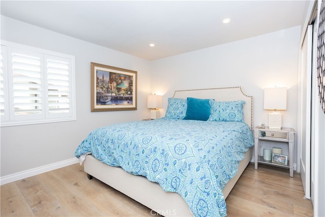 bedroom with light wood finished floors, recessed lighting, and baseboards