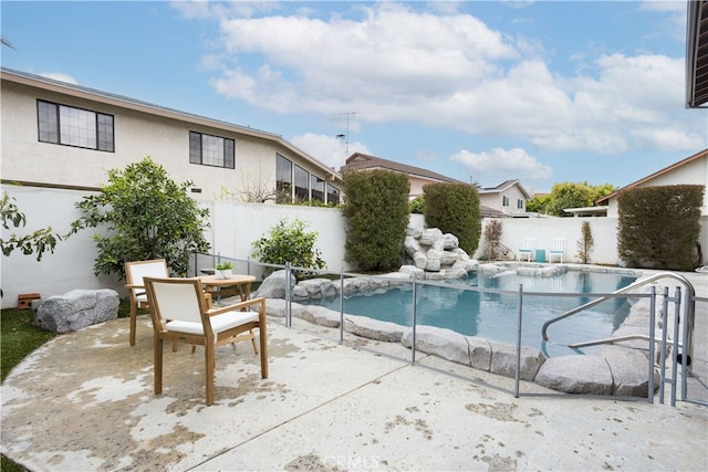 view of swimming pool with a patio area, a fenced in pool, outdoor dining area, and a fenced backyard