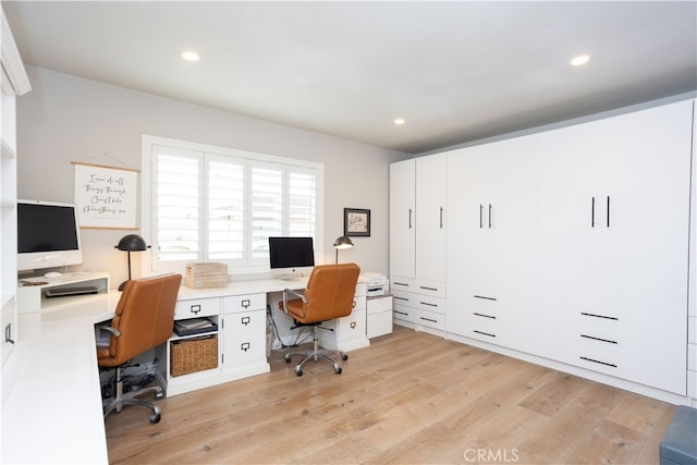 home office with light wood-style flooring and recessed lighting