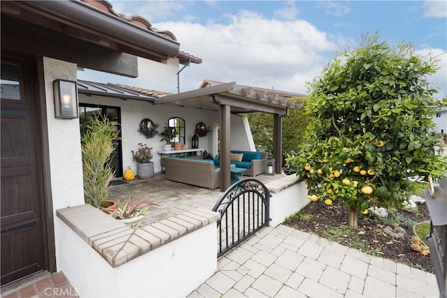 view of patio featuring outdoor lounge area and a gate