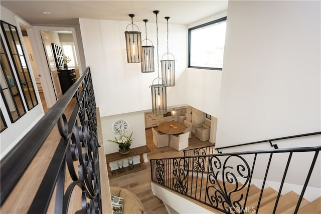 stairway featuring plenty of natural light and wood finished floors