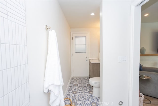 bathroom with recessed lighting, baseboards, toilet, and tile patterned flooring