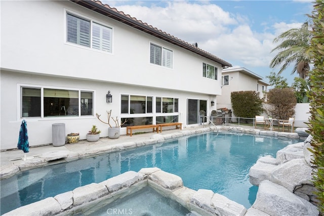 view of pool with a patio and a pool with connected hot tub