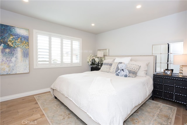 bedroom with recessed lighting, baseboards, and wood finished floors