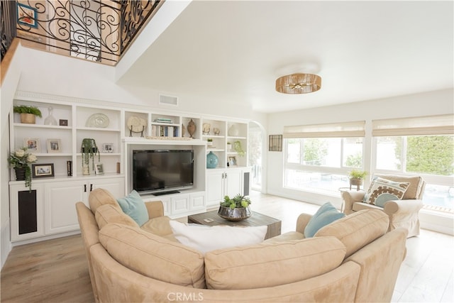 living area featuring light wood-type flooring and visible vents