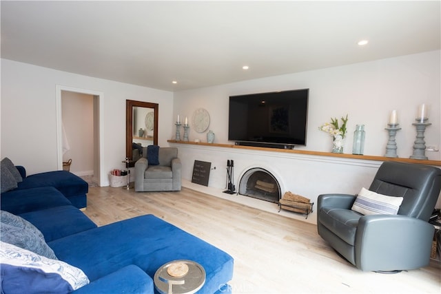 living area with recessed lighting and wood finished floors