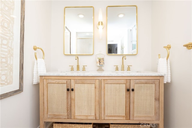 bathroom featuring a sink and double vanity