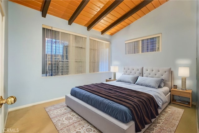 carpeted bedroom featuring lofted ceiling with beams, baseboards, and wood ceiling