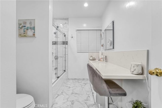 bathroom with marble finish floor, toilet, vanity, and shower / bath combination with glass door