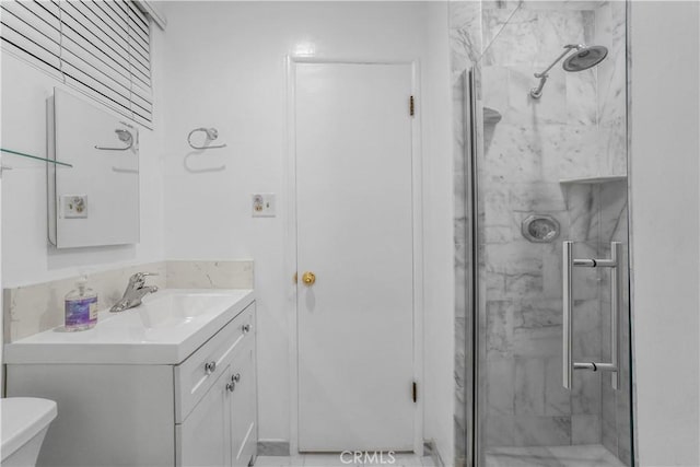 full bathroom featuring toilet, a stall shower, and vanity