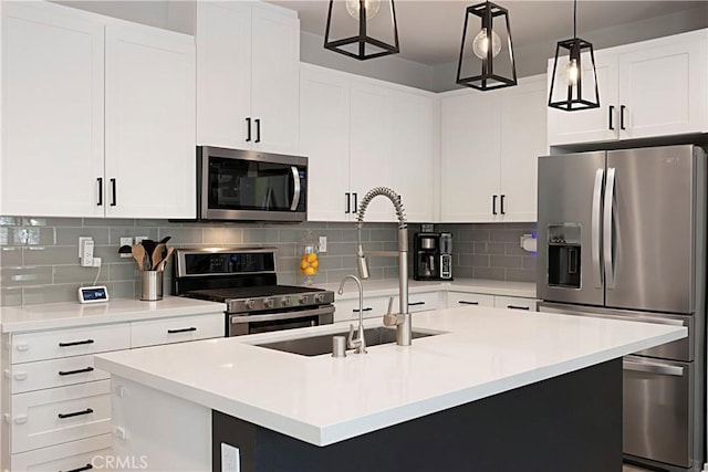 kitchen with a center island with sink, backsplash, appliances with stainless steel finishes, and light countertops