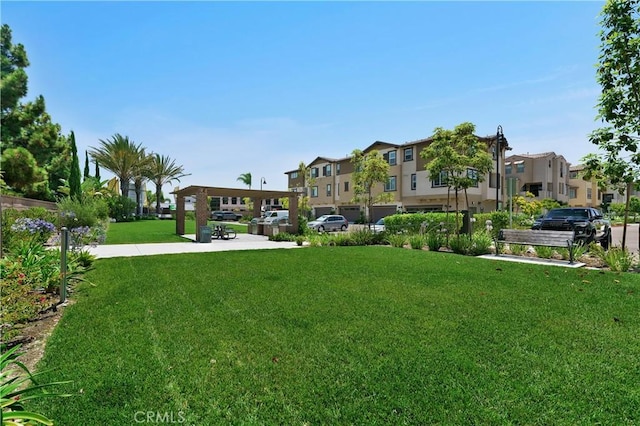 view of community featuring a residential view and a yard