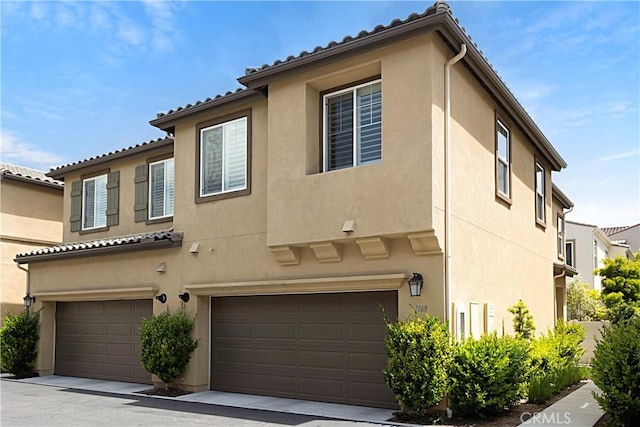 view of front of property featuring a garage and stucco siding