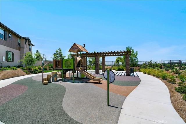 communal playground featuring a pergola and fence