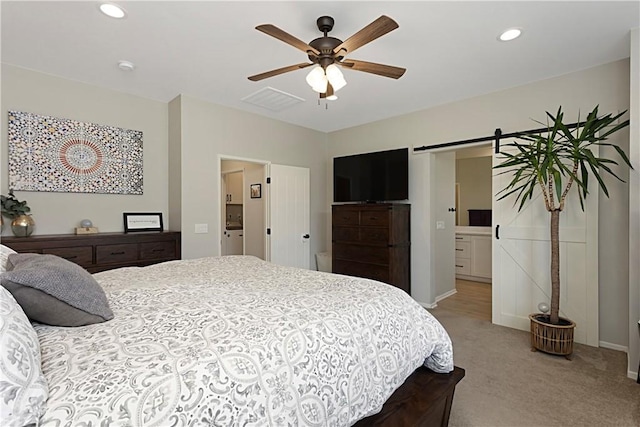 bedroom featuring visible vents, light colored carpet, a barn door, recessed lighting, and a ceiling fan