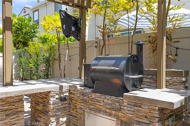 view of patio / terrace with area for grilling and fence