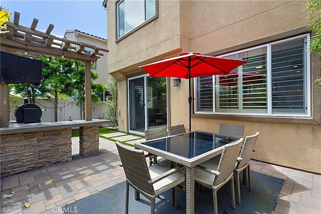 view of patio / terrace with outdoor dining area, fence, and a pergola