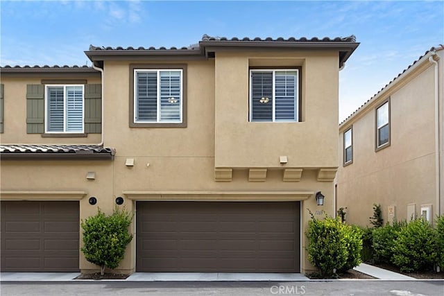 view of property with stucco siding and a garage