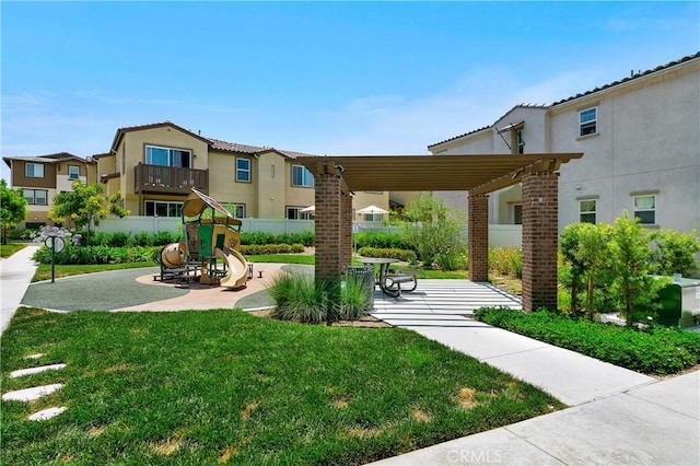 view of property's community with a pergola, a patio, fence, playground community, and a yard