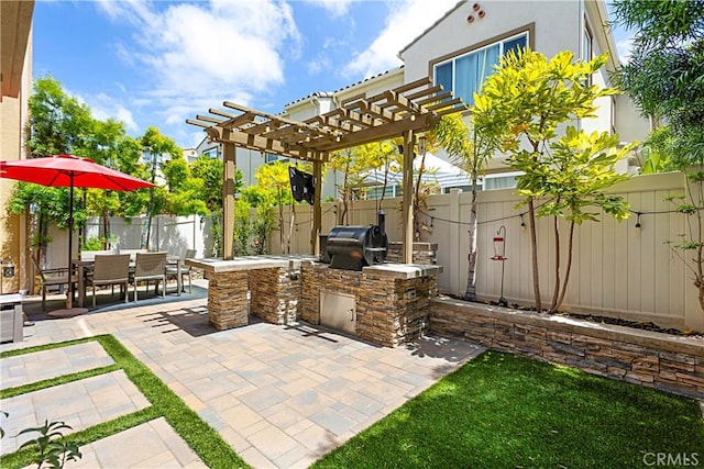 view of patio featuring area for grilling, outdoor dining space, and a fenced backyard