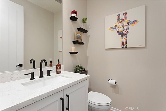 half bath with vanity and toilet