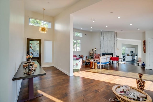 foyer with recessed lighting, a fireplace, baseboards, and hardwood / wood-style flooring